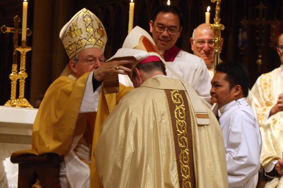 George Pell ordains Peter Comensoli as bishop in 2011.