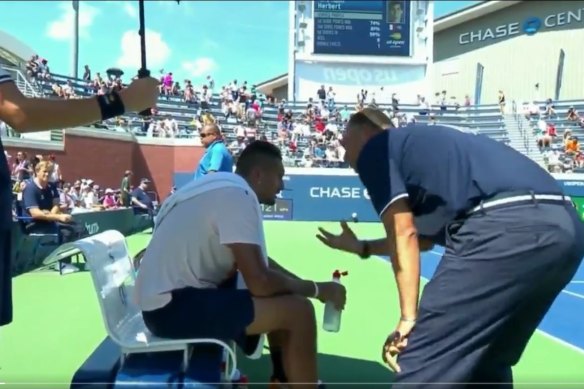 An umpire gives Nick Kyrios a pep talk at the US Open.  