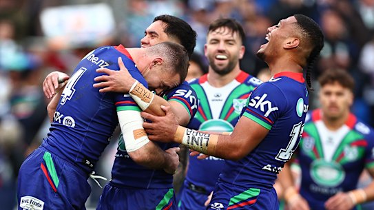 Happy Warriors celebrate a try in their win over Wests Tigers.