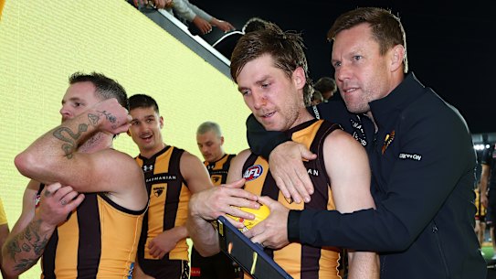 Dylan Moore is embraced by coach Sam Mitchell after overcoming a tumultuous period off the field to shine on it.