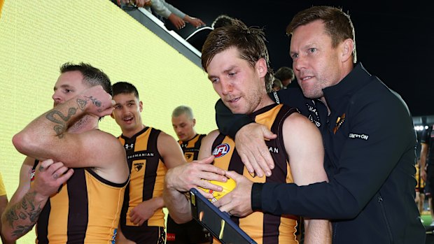 Dylan Moore is embraced by coach Sam Mitchell after overcoming a tumultuous period off the field to shine on it.