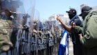 Protesters confront a line of the California National Guard in downtown Los Angeles on Sunday.
