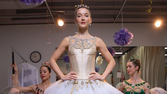 Volunteers Naomi Otton and Marcia Bergh put the finished touches on dancer Benedicte Bemet’s dress.