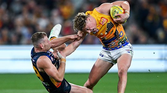 Crows tackler Rory Laird tries to strip the ball from Eagle Harley Reid at the weekend.