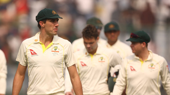 Pat Cummins leads the team off the ground after the loss to India on day three of the second Test.