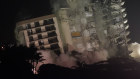 The damaged remaining structure at the Champlain Towers South condo building collapses in a controlled demolition. 