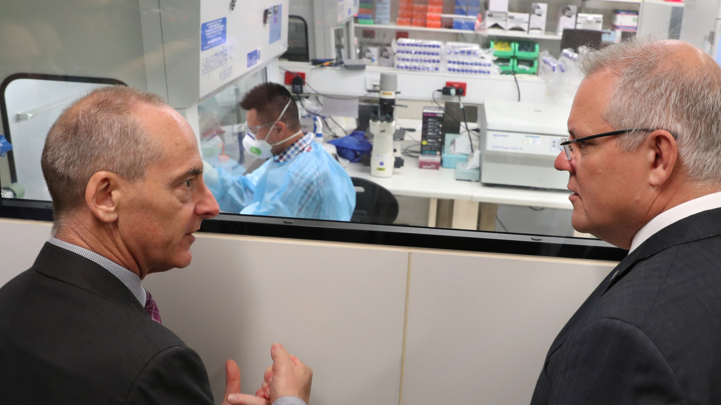 Dr Mike Catton explains to Prime Minister Scott Morrison  how the virus was grown.
