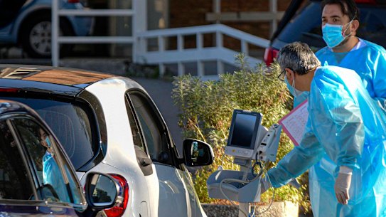 People are being treated inside their cars as they line up outside the emergency ward of a hospital in Naples.