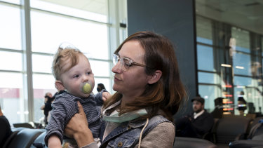 Nina Lacy and her eight-month-old son, Luca, have flown to meet her husband's family in Adelaide. 