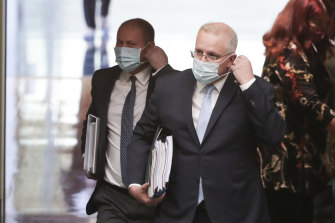 Treasurer Josh Frydenberg and Prime Minister Scott Morrison arrive wearing masks ahead of question time in August last year.