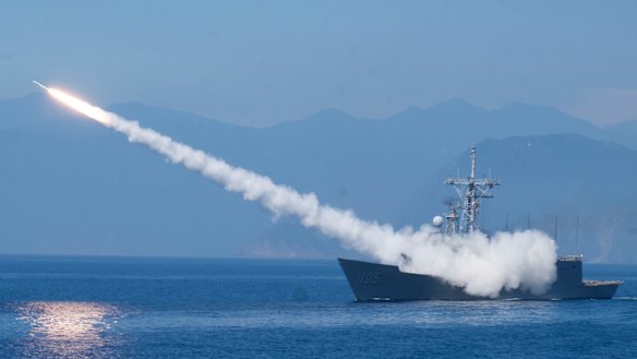 A Taiwanese frigate fires an anti-air missile. Chinese and Taiwanese and Chinese forces have staged rival military demonstrations in the Taiwan Strait amid heightened tensions.