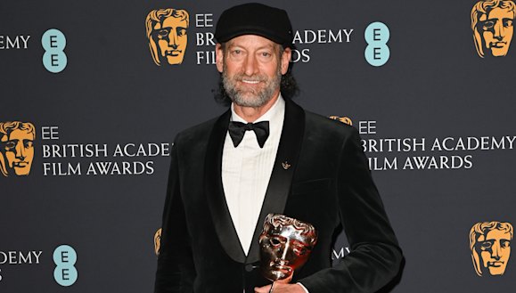 Troy Kotsur with his award for best supporting actor for CODA. 