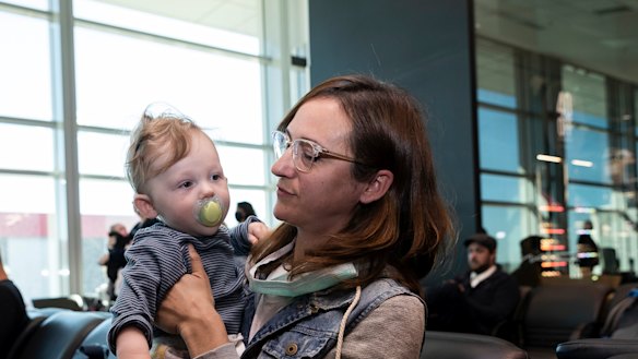 Nina Lacy and her eight-month-old son, Luca, have flown to meet her husband's family in Adelaide. 