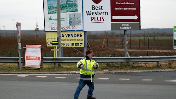 Yellow vest protestrr Michel, no family name available, directs the traffic on a roundabout near Senlis, north of Paris.