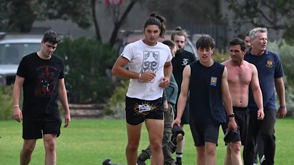 Jacob Hersant, in black and red T-shirt, and others conduct fitness drills in Elwood.