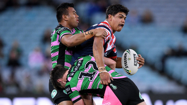 Hard to stop: Man of the moment Latrell Mitchell of the Roosters attempts an offload.