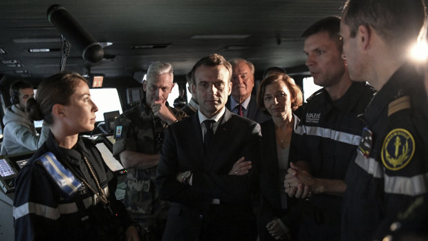 Emmanuel Macron (centre), French Defence Minister Florence Parly (centre-right) and French army chief of staff General Francois Lecointre (centre-left) speak with crew members on the bridge of the Charles de Gaulle aircraft carrier.