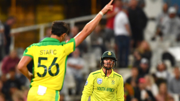 Mitchell Starc celebrates the dismissal of South African captain Quinton de Kock at Cape Town.