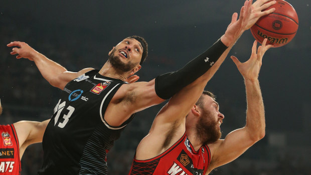 Melbourne United's Josh Boone takes on Perth Wildcat Nick Kay in game 4 of the grand final series.