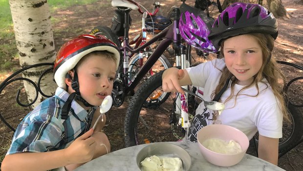 Tim's eight-year-old daughter Emily (right) and her five-year-old cousin Lachlan Hartmann enjoy an ice cream break while riding around Yarralumla.