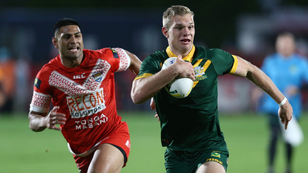 Centre of the action: Tom Trbojevic streaks away from Tonga's Daniel Tupou on Saturday night.