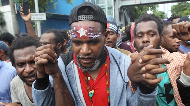 A Papuan activist displays the banned separatist "Morning Star" flag at a rally for the 57th anniversary of the failed efforts by Papuan tribal chiefs to declare independence from Dutch colonial rule, in Surabaya, East Java, on Saturday.