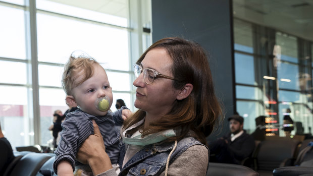 Nina Lacy and her eight-month-old son, Luca, have flown to meet her husband's family in Adelaide. 