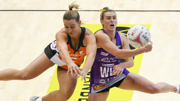 Giant Jamie-Lee Price (left) fights for the ball with Gabi Simpson of the Firebirds on Sunday.