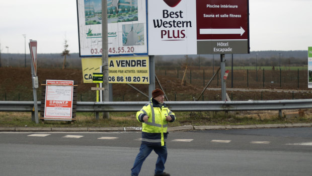 Yellow vest protestrr Michel, no family name available, directs the traffic on a roundabout near Senlis, north of Paris.
