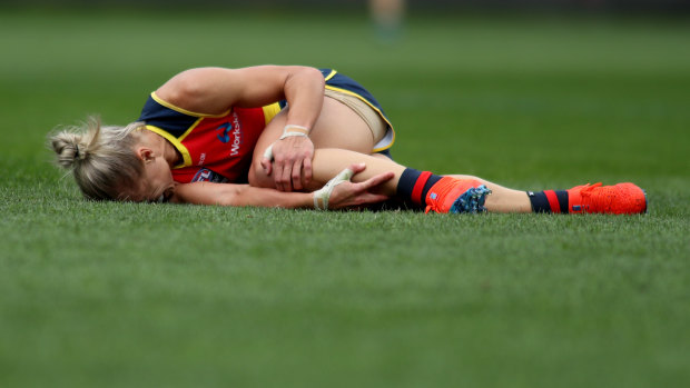 Erin Phillips clutches her knee after going down in the third quarter of the grand final.