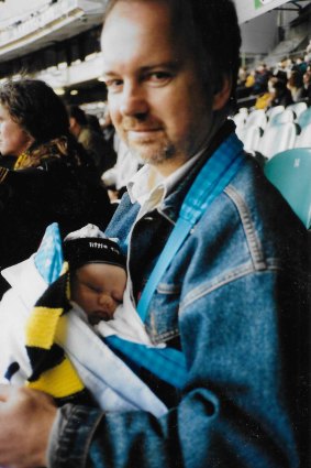 Claire Heaney’s newborn daughter wears Richmond colours at her first trip to the MCG.