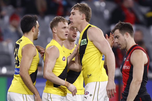 Noah Cumberland (front left) celebrates a goal with teammates.
