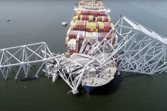 An image taken from video released by the National Transportation and Safety Board, the cargo ship Dali is stuck under part of the structure of the Francis Scott Key Bridge.