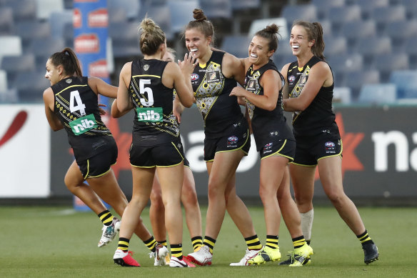 Ellie McKenzie celebrates a goal with Richmond teammates at GMHBA Stadium.