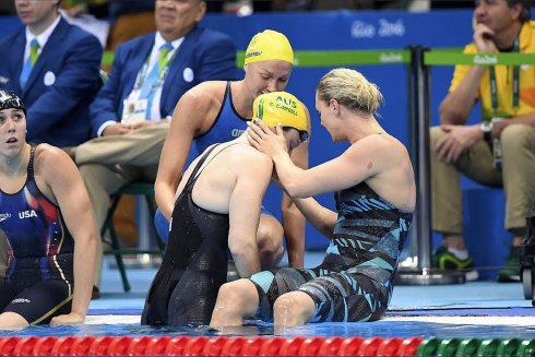 Cate Campbell is comforted by Sweden’s Sarah Sjostrom and Denmark’s Jeanette Ottesen after her shock 100m loss.