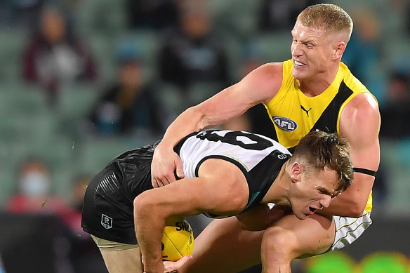 Josh Caddy (right) have up a much-discussed 50 metre penalty in Richmond's loss to Port Adelaide.