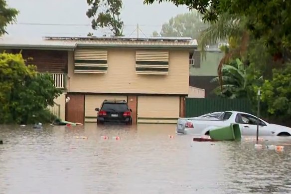 A flooded street in Moreton Bay in  January 2024. Dr Grinham says the 2022 flood dumped mud across a staggering 98 per cent of the bay.