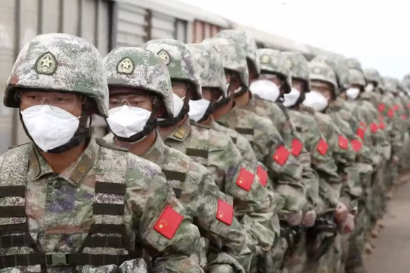 Chinese soldiers arrive at a railway station to participate in war games drills, in Grodekovo, Primorsky Krai, Russia in August.