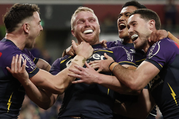 Josh King (centre) celebrates with teammates after scoring a try.