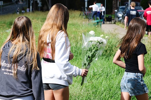 Children bring flowers to the crash site.