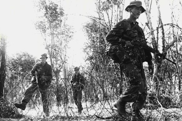 Members of the 1st Battalion, Royal Australian Regiment, patrol outside the perimeter of fire support base Coral in South Vietnam’s Bien Hoa Province, following several attacks on the base in May and June 1968.