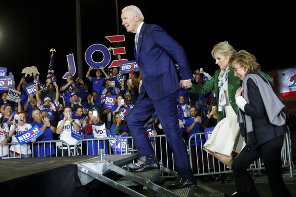 Joe Biden arrives with his wife Jill Biden, left, and sister Valerie Biden, right, to a primary night rally in Los Angeles last year.