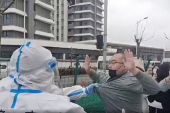 Residents seen fighting with  health workers in Shanghai last month. 