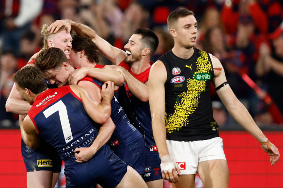 Clayton Oliver celebrates a crucial goal with his Melbourne teammates.