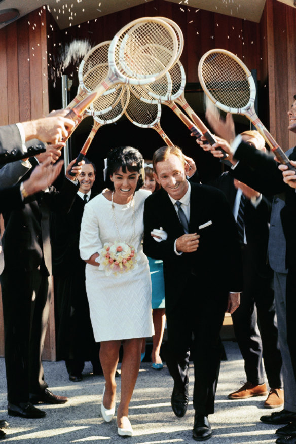 Rod Laver and Mary Benson pass through an arch of tennis racquets after their marriage in 1966.