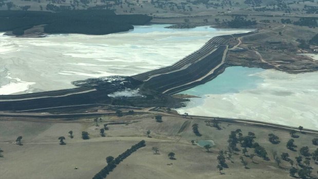 An aerial image showing the collapsed section of the tailings dam.