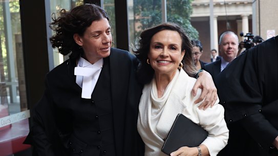 Sue Chrysanthou, SC, hugs Lisa Wilkinson as they emerge victorious from the Federal Court.