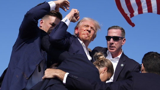Republican presidential candidate former President Donald Trump is surround by U.S. Secret Service agents at a campaign rally, Saturday, July 13, 2024, in Butler, Pa. (AP Photo/Evan Vucci)
