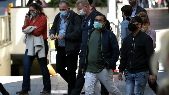 BRISBANE, AUSTRALIA - JULY 13: People walk through the CBD on July 13, 2021 in Brisbane, Australia. Queensland has recorded two new local COVID-19 cases overnight, but as the people were in home quarantine and are linked to known cases, premier Annastacia Palaszczuk has confirmed the planned easing of coronavirus restrictions will go ahead at the end of the week. Restrictions in Queensland will ease from 6am, Friday 16 July, with residents allowed to leave home for any reason self-isolating as a close contact or awaiting test results. Face masks will no longer be required except for at airports and on planes. Shops, restaurants, cafes, cinemas, gyms, beauty services and other businesses can operate subject to density limits and COVID-safe rules, while dancing will also be permitted. Indoor gatherings will increase to 100 people while there is no limit on the number of people for outdoor weddings or funerals. (Photo by Jono Searle/Getty Images)