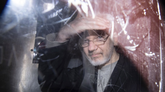 Wikileaks founder Julian Assange leaves in a prison van after appearing in court in January.